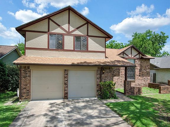 Beautiful curb appeal with front porch and mature trees.