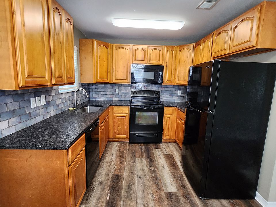 lUXURY VINYL PLANK, LEATHERED GRANITE, AND LARGE UNDERMOUNT SINK WITH DRAINING GRID. LED LIGHTS, NEW FRIDGE AND A/C. DISHWASHER. LOTS OF STORAGE SPACE IN KITCHEN.