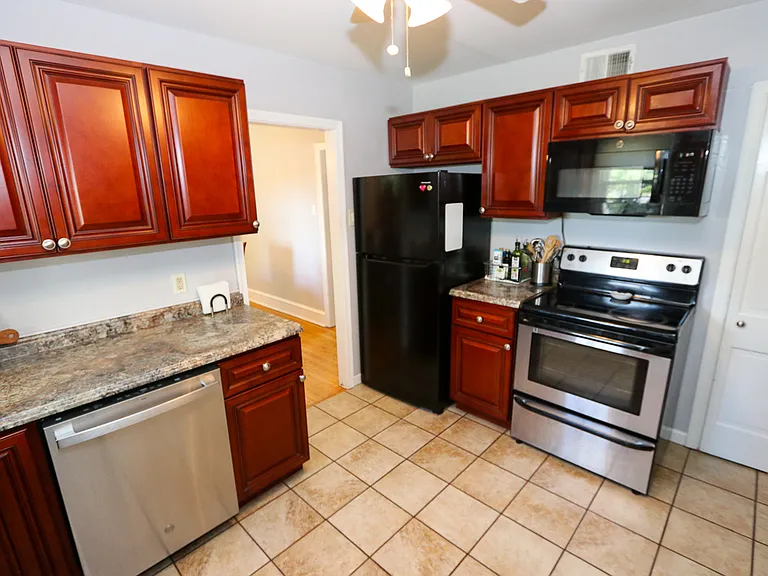 Updated kitchen with black/stainless appliances complete with dishwasher