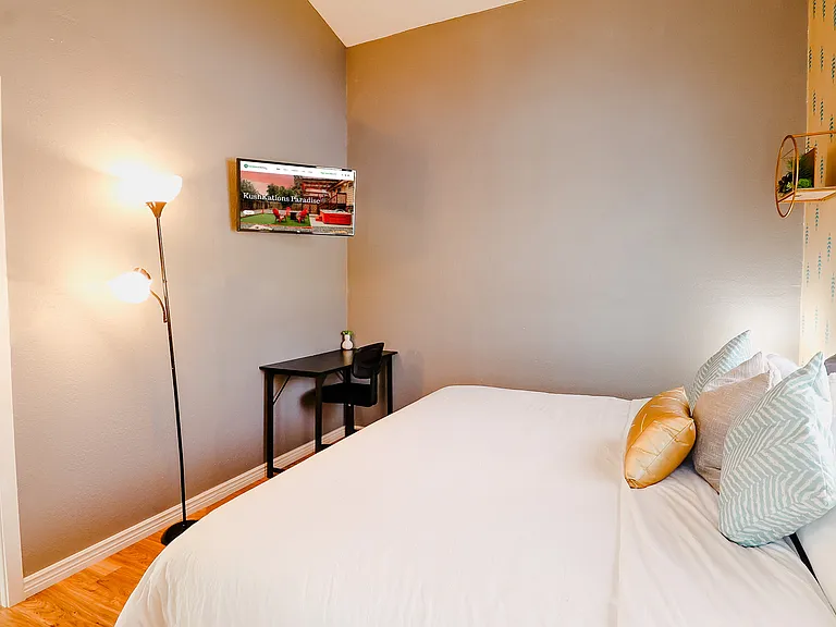 A bedroom centered around a soft bed, offering a plush and inviting sleep experience that envelops you in ultimate comfort and relaxation.