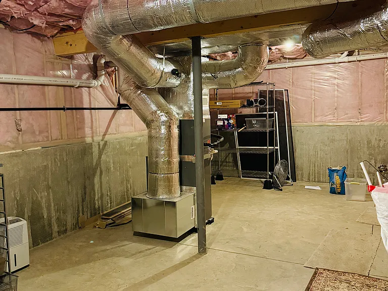 Basement. A floor below the main floor. A door to the right leads to the garage.