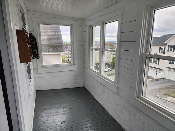 Three season porch on the street front side of the unit.