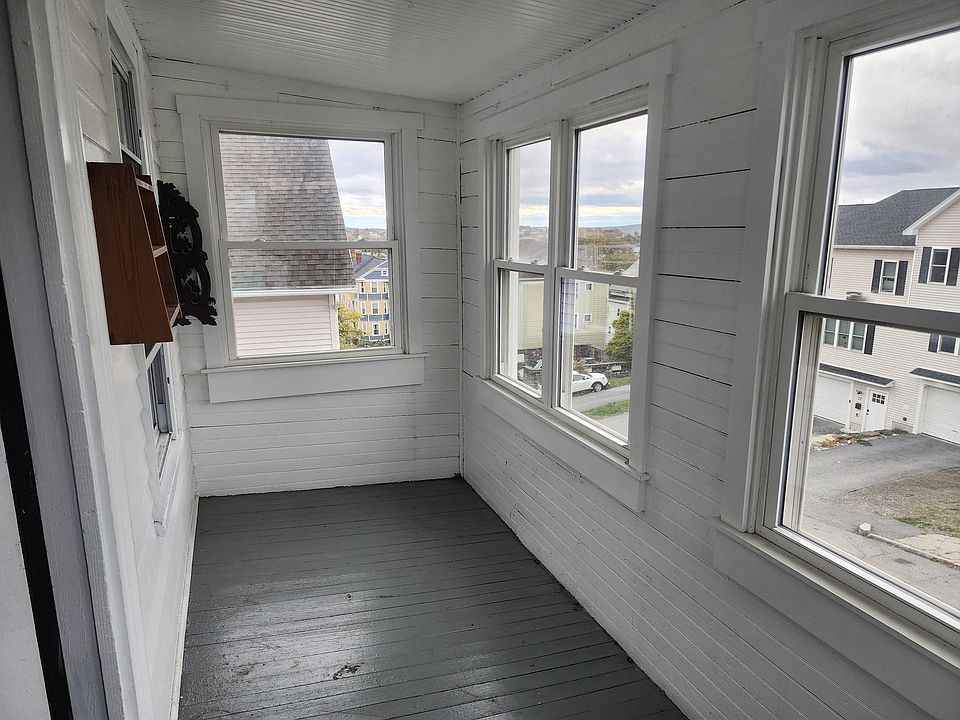 Three season porch on the street front side of the unit.