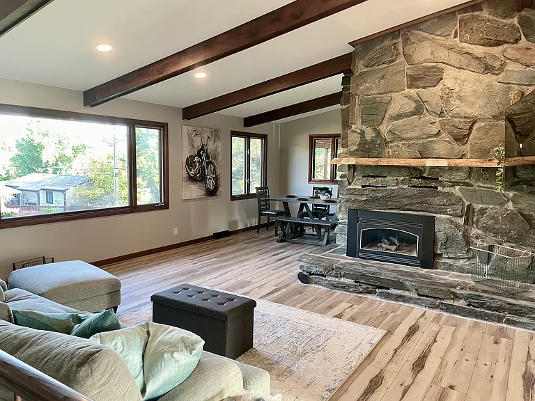 Great room, picturing the living room seating, fireplace and dining areas.