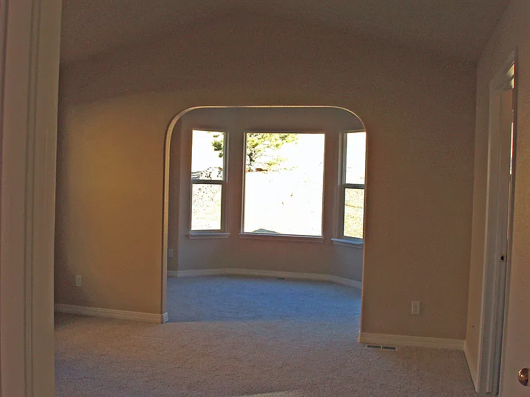 Master Bedroom - sitting area looking out at open space. Sliding door on right to Patio.