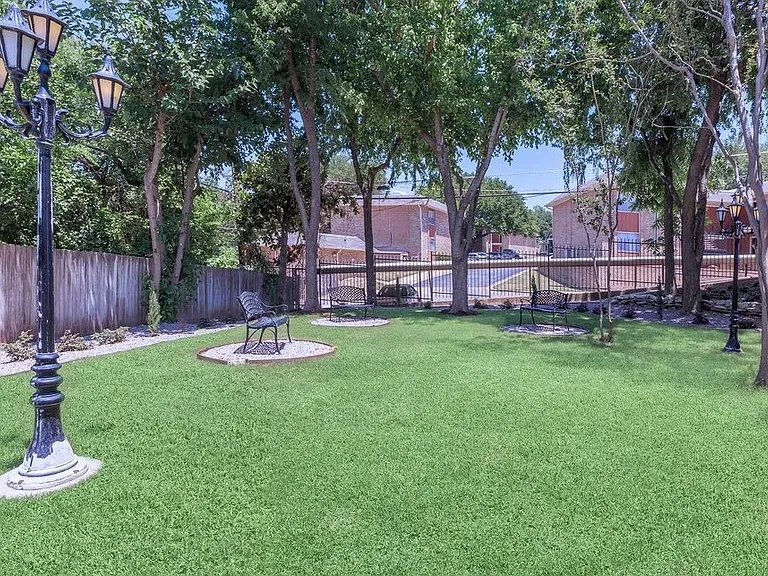 Peaceful community grounds with shaded trees, picnic seating, and well-kept pathways.