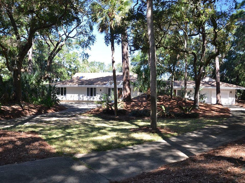 Front of house with a large circular driveway.