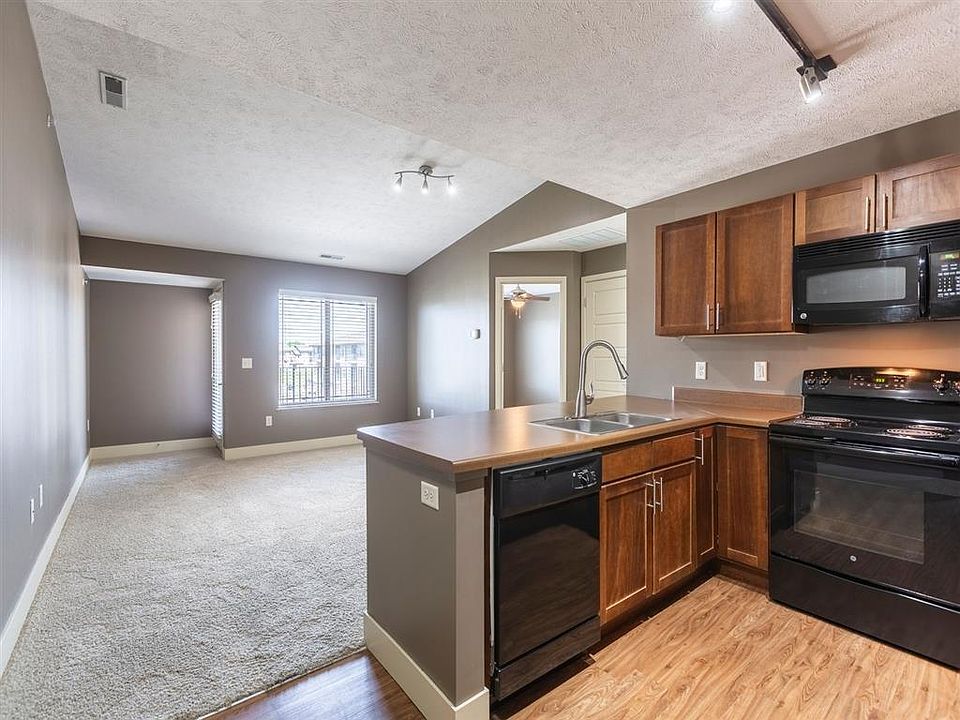 A kitchen with a stove, oven, and microwave The Sterling Grand Island.