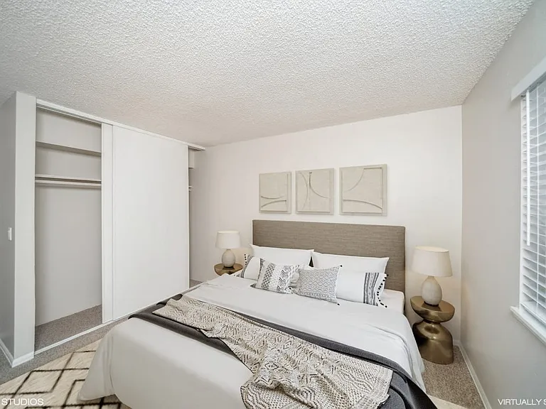Bedroom with closet space and plush carpeting for added warmth and function