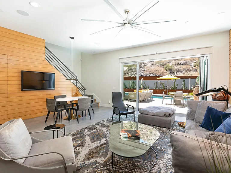 Great room with view of the backyard and staircase to the bedrooms.