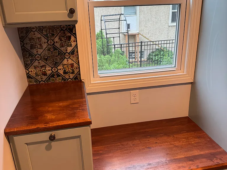upstairs kitchen nook. this has a draw under the window seat and to the left, there is a special pull out cabinet, originally intended for dog food.