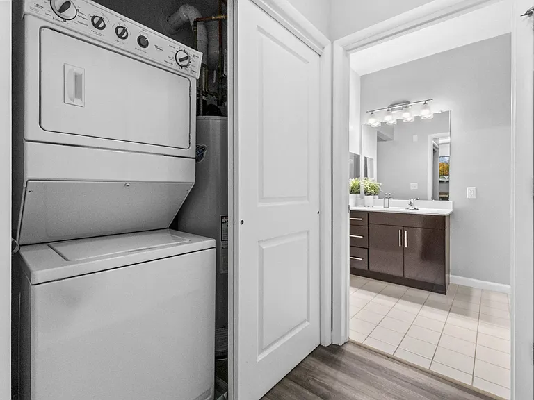 a washer and dryer in a kitchen with a bathroom in the background at Harbor Pointe, Bayonne, New Jersey