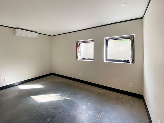 Bedroom with heated concrete floor and split unit for heat and AC
