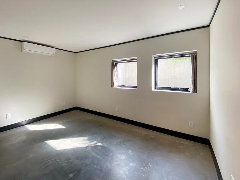 Bedroom with heated concrete floor and split unit for heat and AC