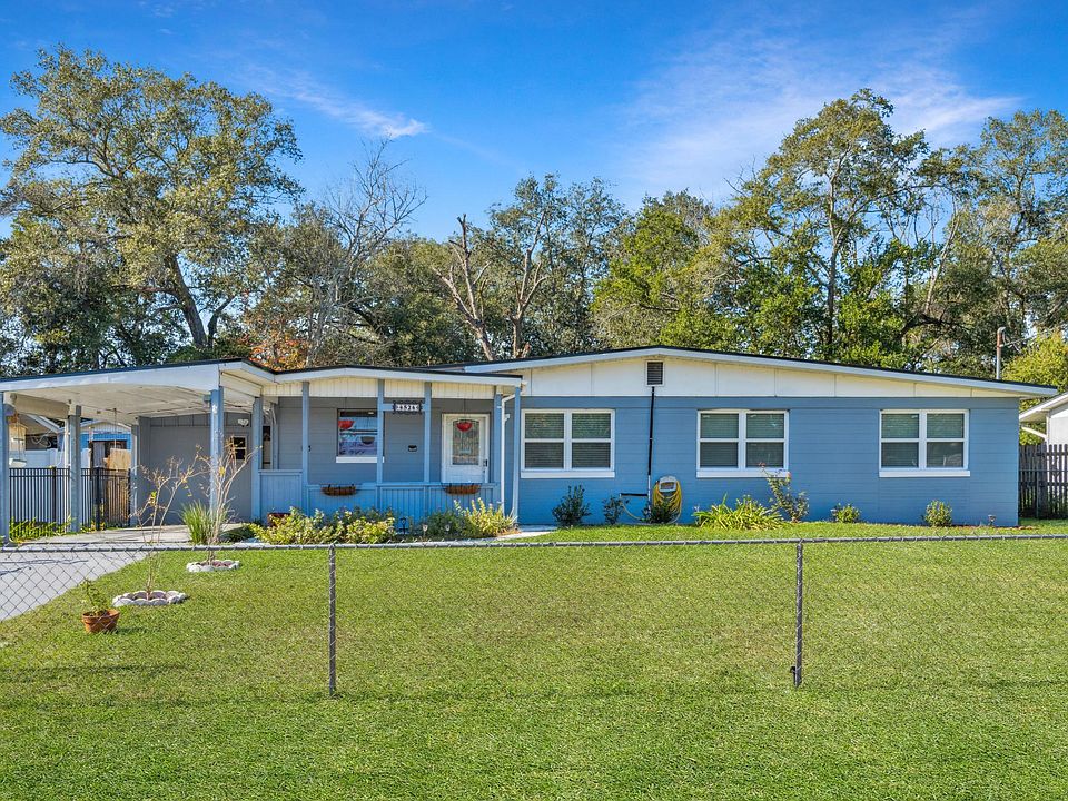 Exterior property with fenced yard and parking space.