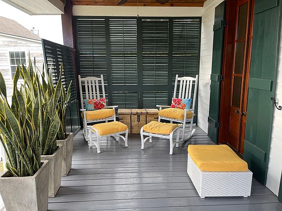 Front porch with privacy shutters, rockers and a wonderful view of the lake.