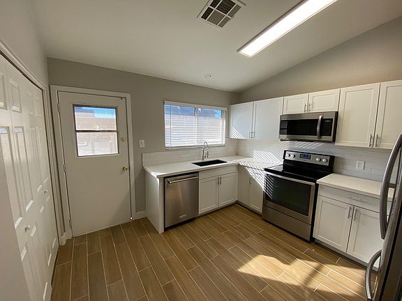 Back door leading to private patio/single bowl under mount ceramic sink