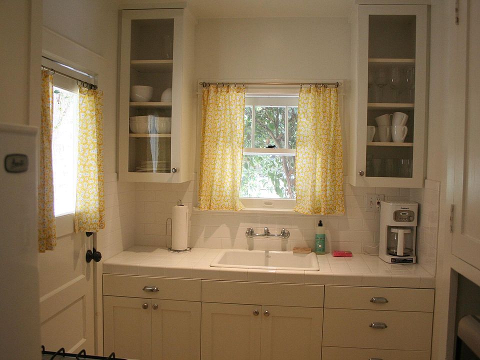 Kitchen with range, microwave and refrigerator