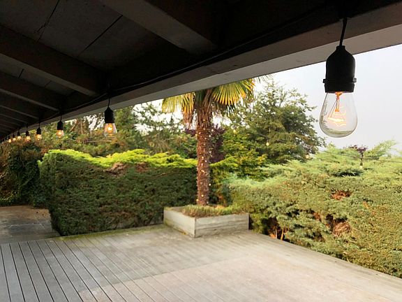 Lights adorn the roofline and border the deck