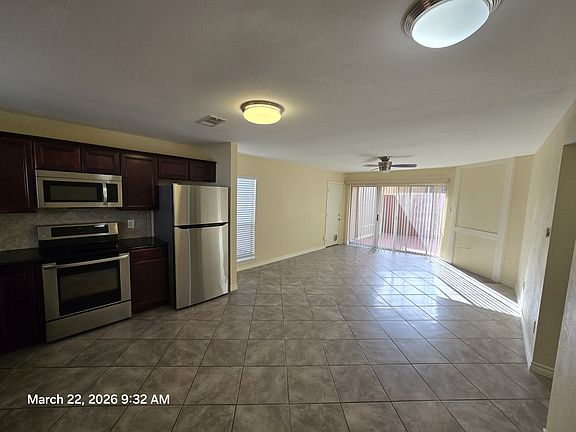 Tile flooring, sliding doors towards the porch area. Open floorplan for dining and living area.