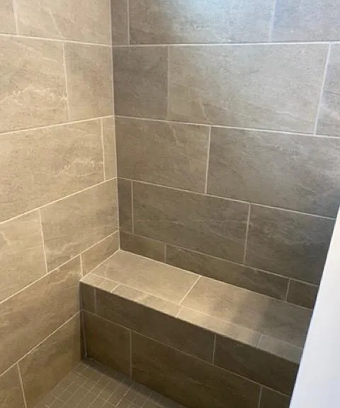 seat in walk-in shower in master bathroom