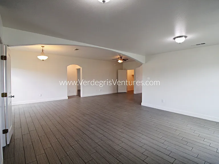A spacious, open_concept layout connecting the kitchen, living, and dining areas.