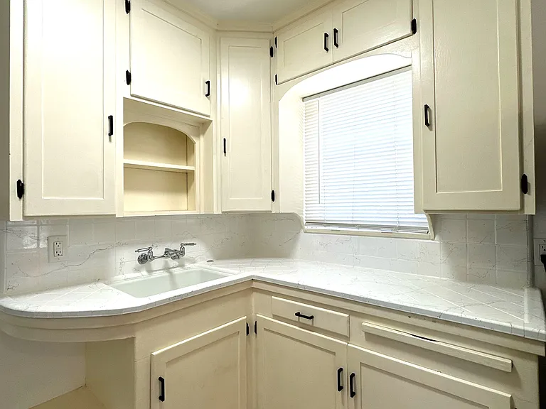 Kitchen with new counters, hardware and garbage disposal