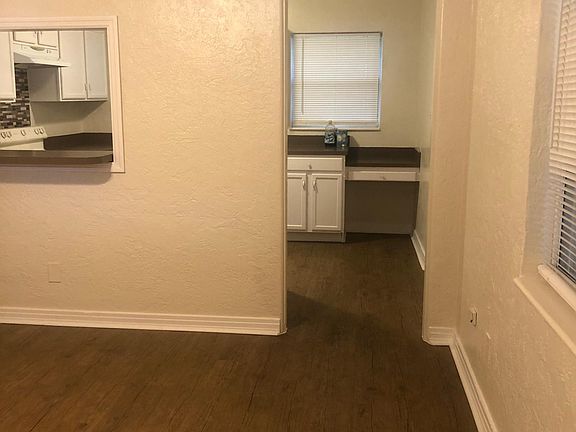 View of kitchen from living room front door entry