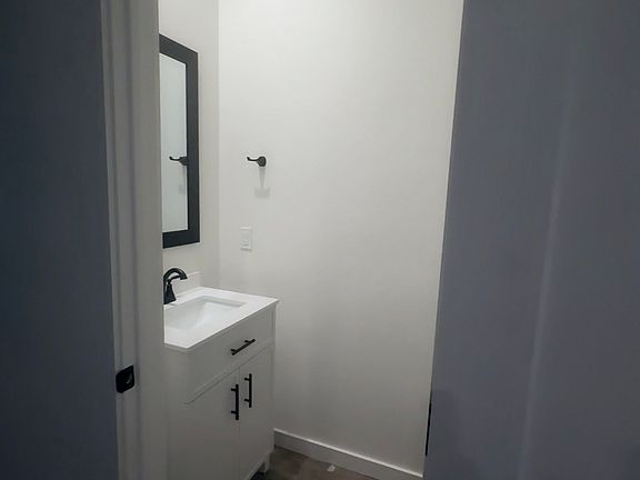 Powder room on lower level. Vanity for extra storage