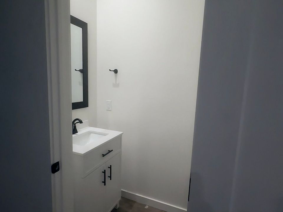 Powder room on lower level. Vanity for extra storage