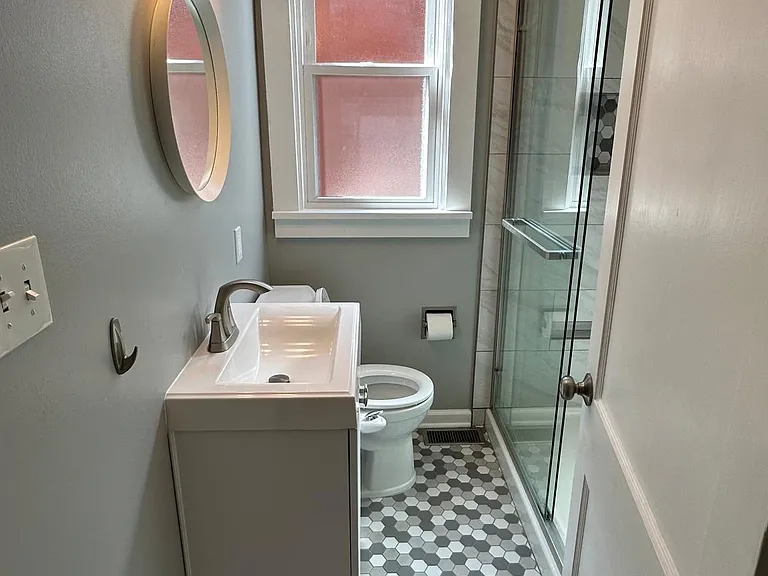 Updated bathroom with marble shower and accent tile