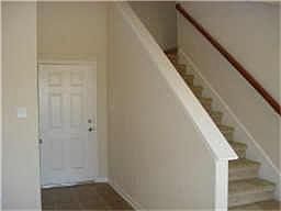 Entryway Has Coat Closet and Art Shelf.