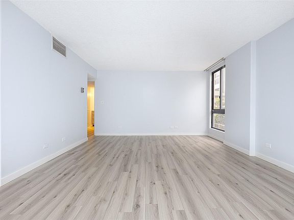 Large bright living room with new vinyl flooring throughout.