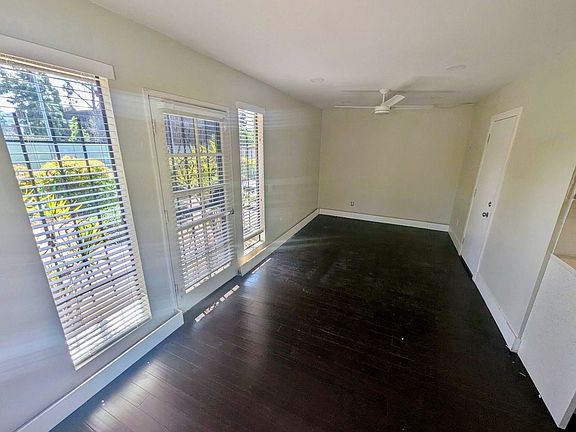 Dining area/office in foreground with living space in background.