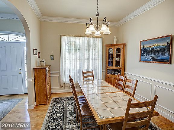 Formal dining off kitchen w crown and chair rail