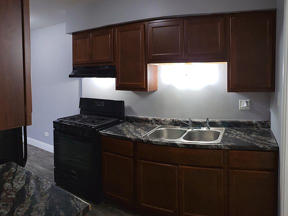 Brand New Kitchen Featuring Black Appliances