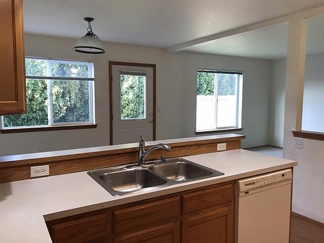 Kitchen looks out to private green backyard.