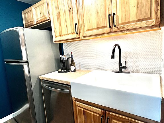 Apron front farmhouse sink and tile backsplash
