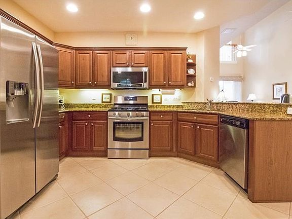 Newer Stainless Appliances, Gas Range, Wood Cabinetry, Granite counters, and Breakfast Bar.
