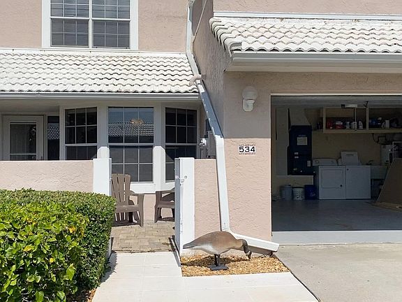 Front view and 2 car garage with washer and dryer