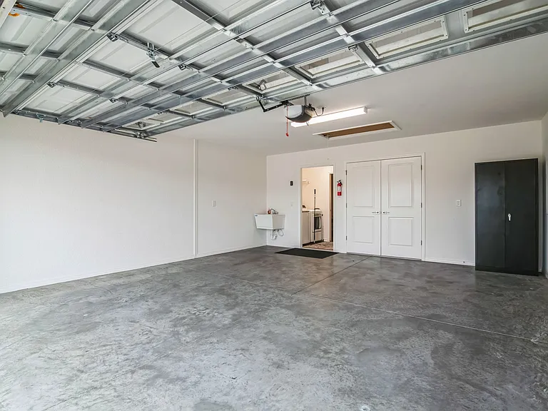 Spacious Two Car Garage with Access to the House through the Laundry Room and Access to the Utility Room for the HVAC Equipment.