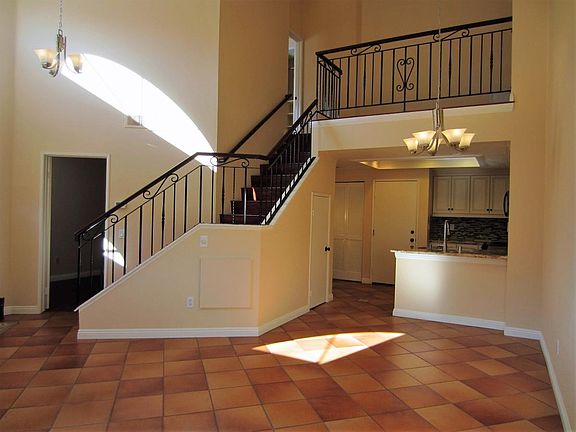 Staircase leads to upstairs loft and master bedroom.