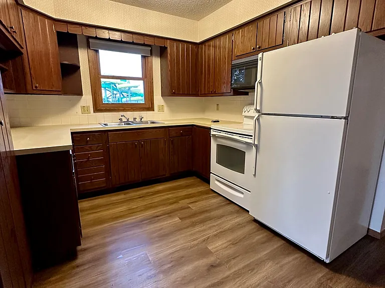 Well-maintained kitchen with original wood cabinetry in excellent condition, generous storage throughout, and a highly functional layout. The space offers an opportunity for cosmetic updates while remaining completely usable and attractive as-is.
