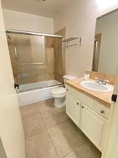 Bathroom ensuite in 1st rear bedroom with travertine tile