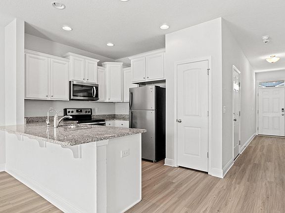 Luxury vinyl plank throughout main floor, stainless appliances and granite counters.
