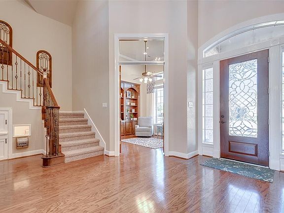 The regal grand entrance hall boasts gleaming hardwood flooring and handsome front door flanked by window panes allowing in plenty of light.