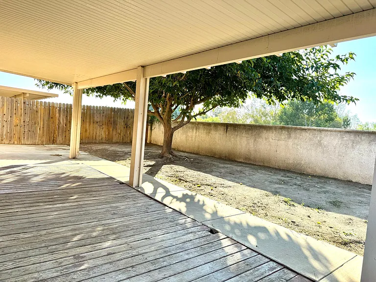 Backyard with broad patio cover, lots of cool shades for you and your guests
