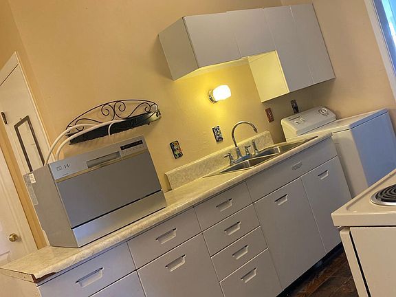 Kitchen with washing machine on the far right.