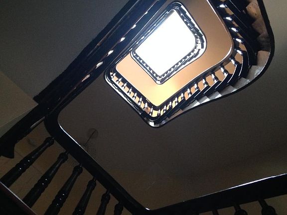 Stair hall in unit goes up four floors and ends in skylight