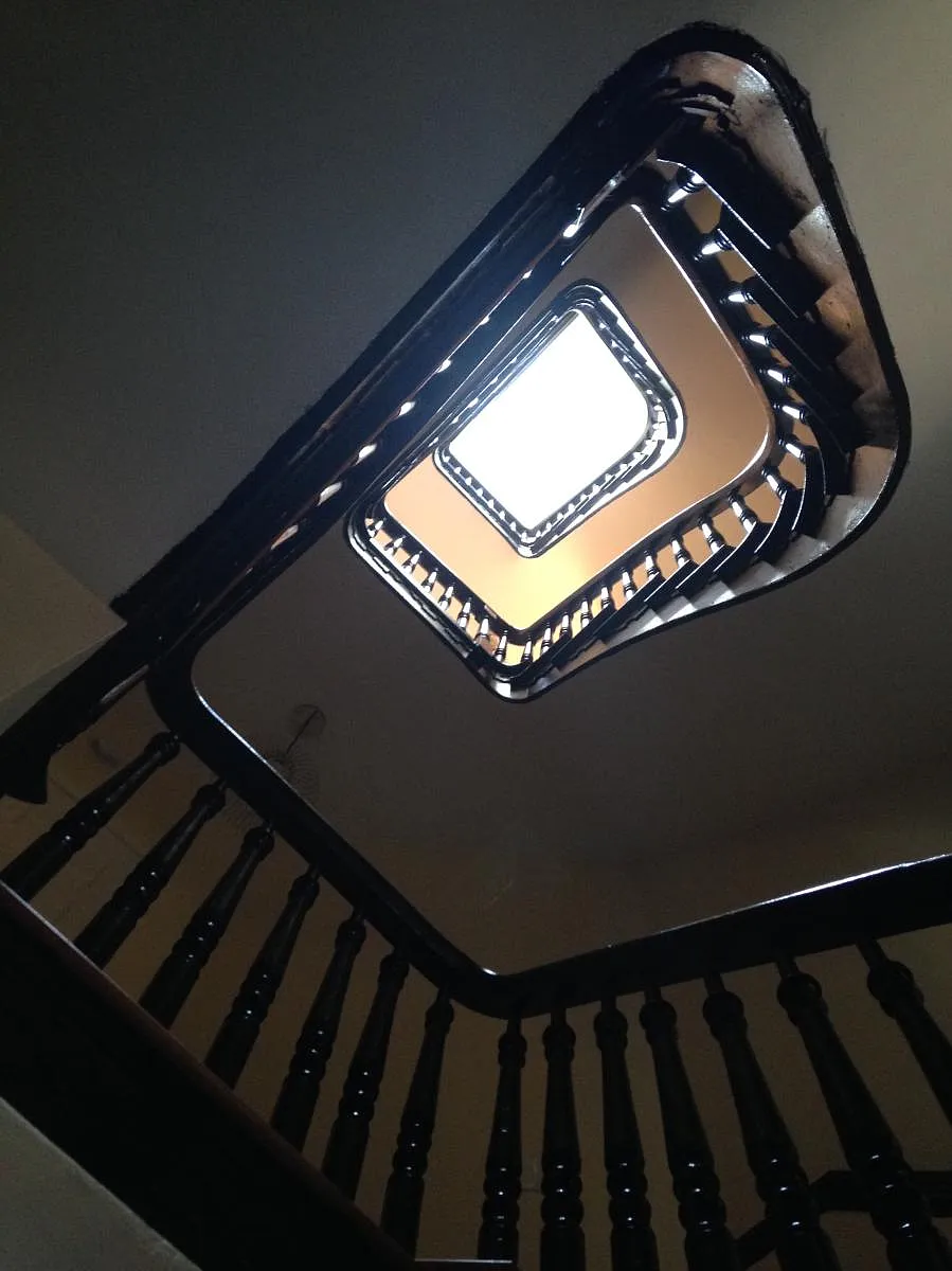 Stair hall in unit goes up four floors and ends in skylight - 153 W Lanvale St #2